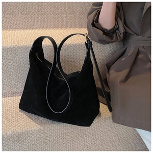 Détail du sac hobo en daim noir mat avec bandoulière en cuir et fermeture éclair