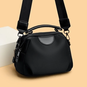 Black nylon shoulder bag with contrasting topstitching and wide adjustable strap