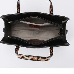 Black pebbled PU leather tote bag with leopard print handles and spacious interior compartments
