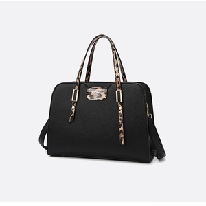 Chic black lychee leather handbag with leopard print details and gold hardware accents