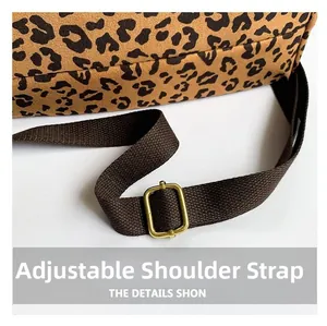 Detail of adjustable shoulder strap with leopard print texture and gold metal buckle