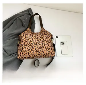 Top view of large leopard print tote bag with brown straps and spacious canvas interior