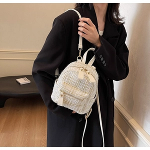 Dettaglio borsa a tracolla in tweed con zip dorate e cinturini regolabili in pelle PU