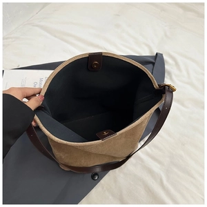 Brown suede bucket bag with magnetic closure and adjustable leather strap for women