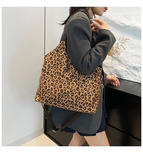 Close-up of leopard print tote bag with wide brown shoulder strap for daily use