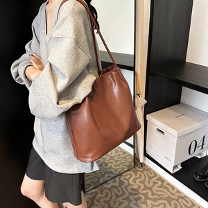 Minimalist brown leather tote bag with long straps for women's daily commute shoulder style