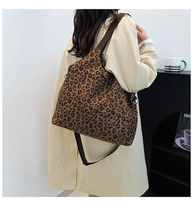 Detail of leopard print canvas shoulder bag showing large capacity and adjustable strap