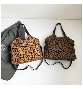 Detail of leopard print tote bags in light brown and dark coffee tones with adjustable straps