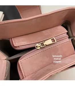 Close-up of pink PU leather bag detail featuring smooth golden zipper and gray lining