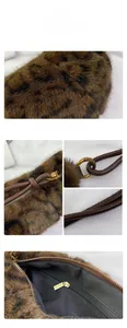 Detail of leopard print faux fur dumpling bag with vintage bronze hardware and leather handle