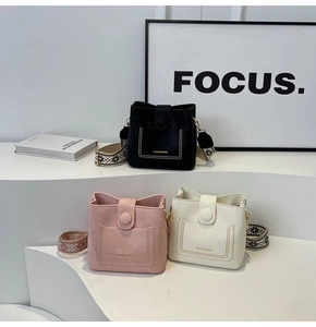 Minimalist bucket bags featuring geometric patterned wide straps and fashion lettering