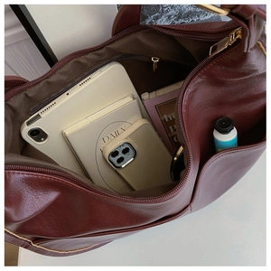 Top view of burgundy tote bag interior showing large capacity for tablet and cosmetics