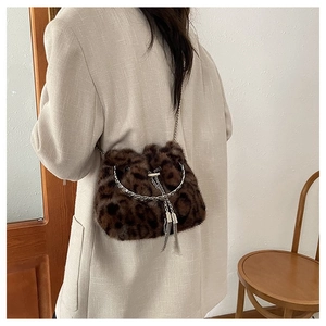 Detail of leopard print faux fur bucket bag with silver chain strap and metal rings