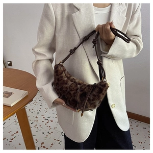 Detail of leopard print faux fur dumpling bag with brown leather strap and knot accent