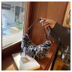 Detail of leopard print faux fur hobo bag with brown knotted leather shoulder strap