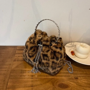 Detail of leopard print faux fur bucket bag with silver chain handle and tassel drawstring