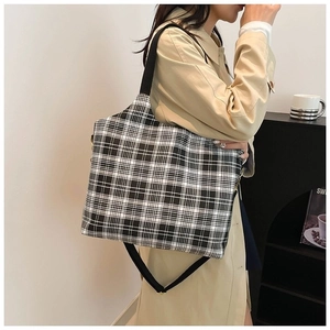 Classic black and white checkered tote bag with wide shoulder strap for daily commuting