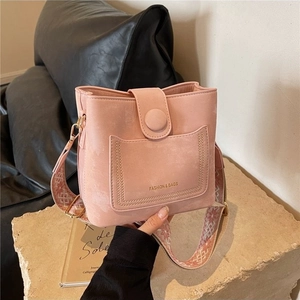 Pink matte bucket bag with a wide jacquard shoulder strap and gold fashion lettering