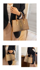 Details der braunen Krokodilmuster-Schultertasche mit goldenen Beschlägen und Beleuchtung