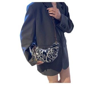 Plush leopard print faux fur crescent bag with elegant brown leather shoulder strap
