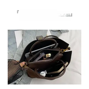Interior view of brown tote bag with multiple compartments for tablet and makeup