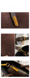 Detailed macro view of dark brown matte leather bag with vintage gold metal buckles