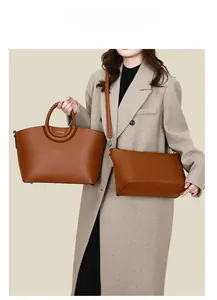 Caramel brown pebbled leather tote bag set with woven handles and crossbody detail