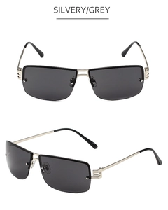 Detail of silvery metal frames and grey rectangular lenses on rimless sunglasses