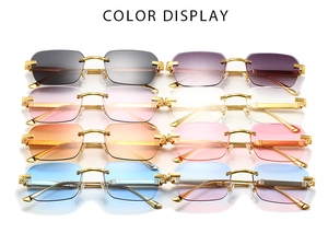 Detailed color display of square rimless sunglasses with gold engraved metal hinges