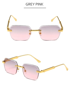 Close-up of grey pink gradient rimless sunglasses with ornate gold metal temples