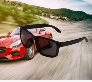 Polarized black sport sunglasses with metal rivets shown on dynamic racing background