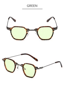 Détail de lunettes de soleil en écaille avec verres vert clair et branches en métal