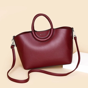 Deep burgundy PU leather tote bag with unique circular woven handle and silver hardware
