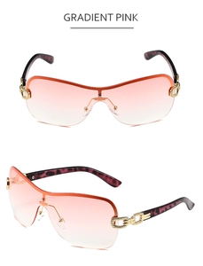 Detail of gradient pink rimless Y2K shield sunglasses with gold chain link hinges