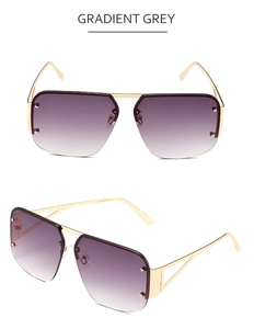 Detail of gradient grey pilot sunglasses with gold metal frames and stud accents