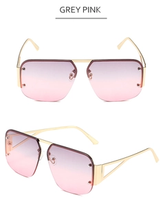 Detail of pilot square sunglasses with grey pink gradient lenses and gold metal frame