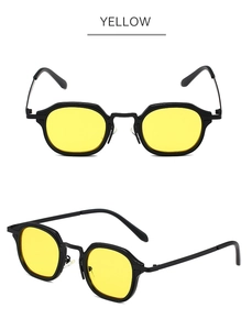 Detail view of vintage small frame sunglasses with black frame and yellow lenses