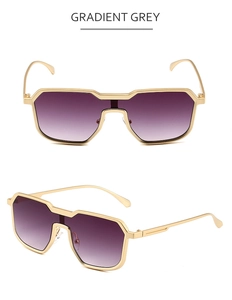 Detail of steampunk irregular metal sunglasses with gradient grey lenses in gold frames