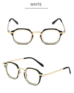 Detail of retro small frame sunglasses with black polygon rims and gold metal temples