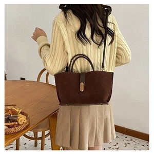 Minimalist dark brown matte suede handbag for women featuring gold oval buckle and strap