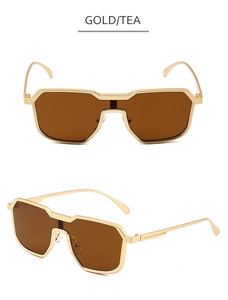 Close-up of steampunk geometric gold metal sunglasses with tea-colored lenses