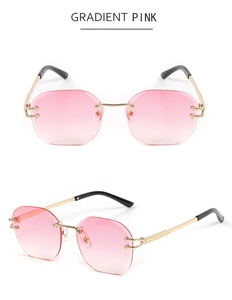 Detail of snake-style metal sunglasses with pink gradient lenses and gold temples