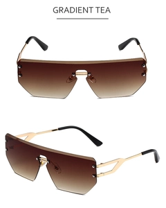 Detail view of rimless shield sunglasses with gradient tea lenses and gold metal frames