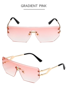 Detail of gradient pink rimless sunglasses with gold metal arms and modern oversized frame