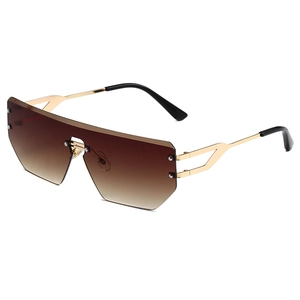 Frameless oversized sunglasses with brown gradient lenses and golden metal temples