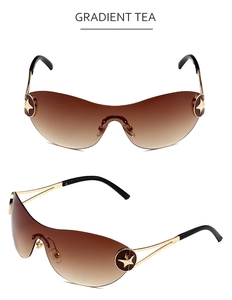 Detail of gradient tea Y2K sunglasses with gold metal star ornament and rimless lens