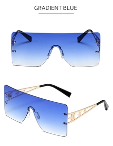 Detail of oversized rimless star sunglasses with gradient blue lenses and gold metal arms