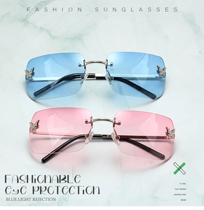 Detail of rimless Y2K sunglasses with gradient lenses and metal butterfly rhinestone accent