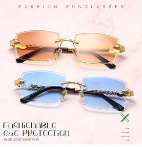 Detail view of golden leopard head hinge on rimless sunglasses with gradient lenses