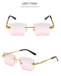 Close-up of rimless sunglasses featuring golden snake-shaped temples and grey-pink gradient lenses